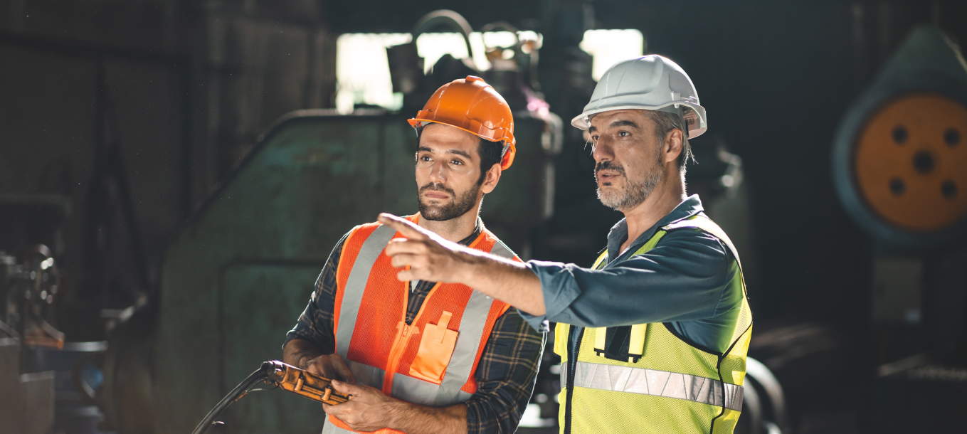Two production employees discuss a topic